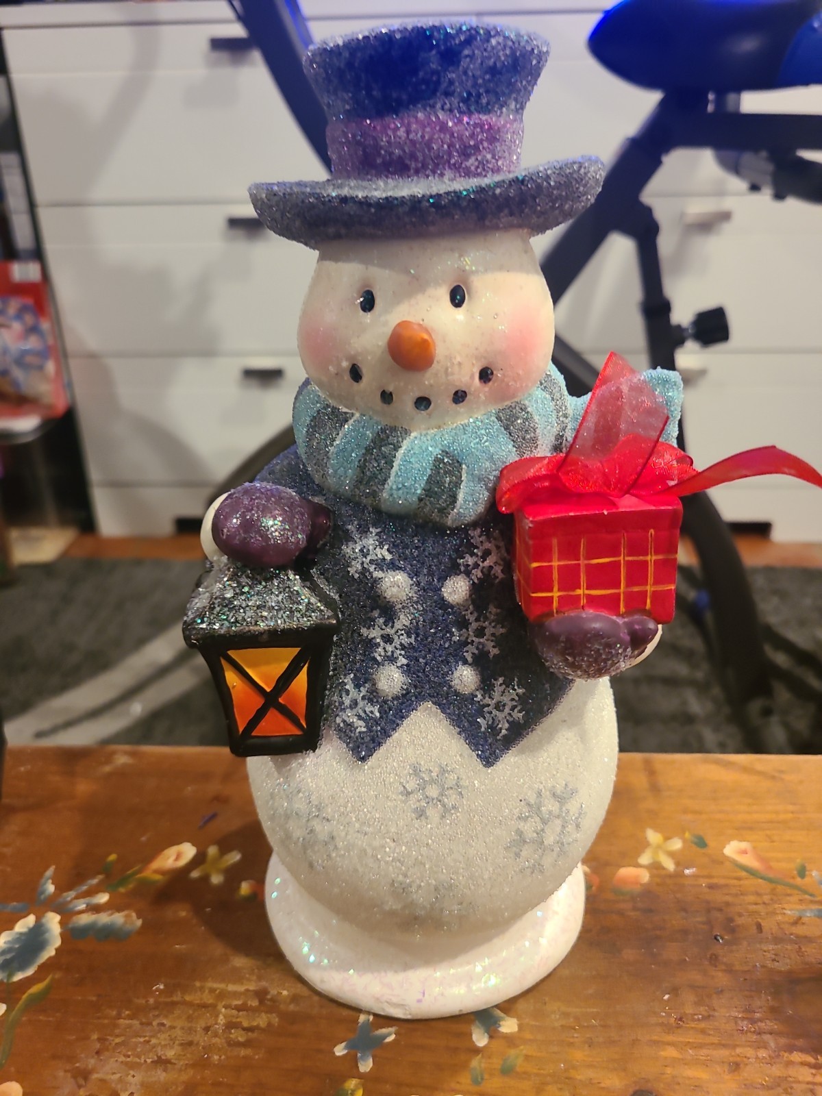 Glitter Snowman 10 1/2 In Tall. Present In One Hand Lantern In Other Hand.