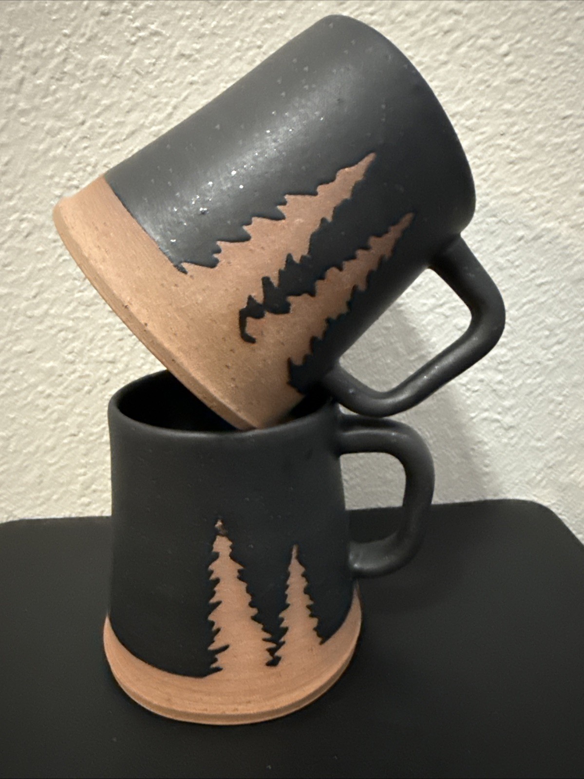 Handmade Mug W/speckled dark glaze/ natural, unglazed bottom Showing Pine Trees