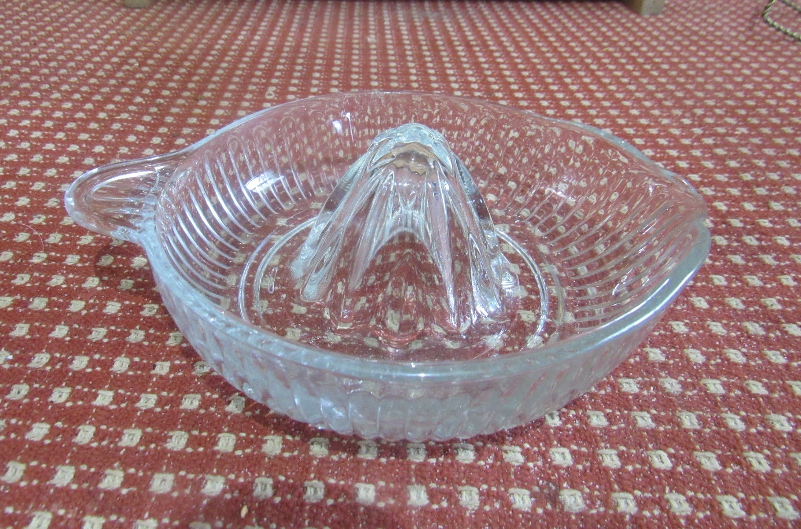 1 Clear Glass Ribbed Juicer. 8″ Handle to Spout x 6″W x 1¼”D x 3″H. No Flaws.