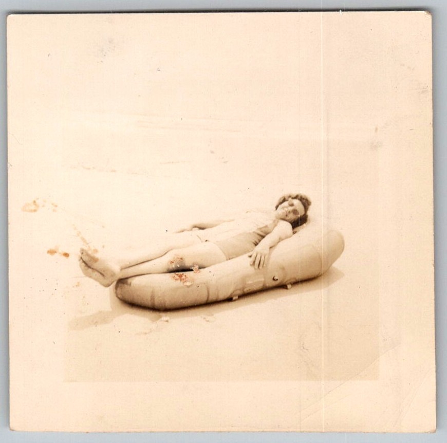 Vtg B&W Snapshot Woman In Swimsuit Relaxing On Inflatable Raft At Beach Circa