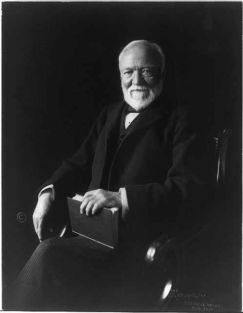 [Andrew Carnegie, three-quarter length portrait, seated holding book]