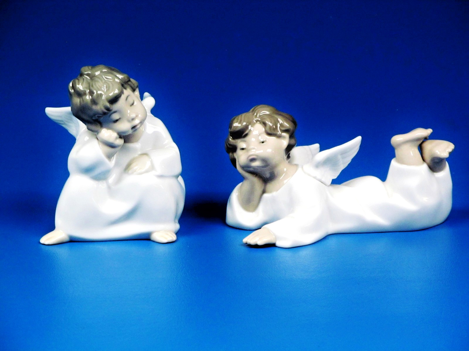 Lladro Thoughtful Angel and Angel Laying Down (lot of 2)