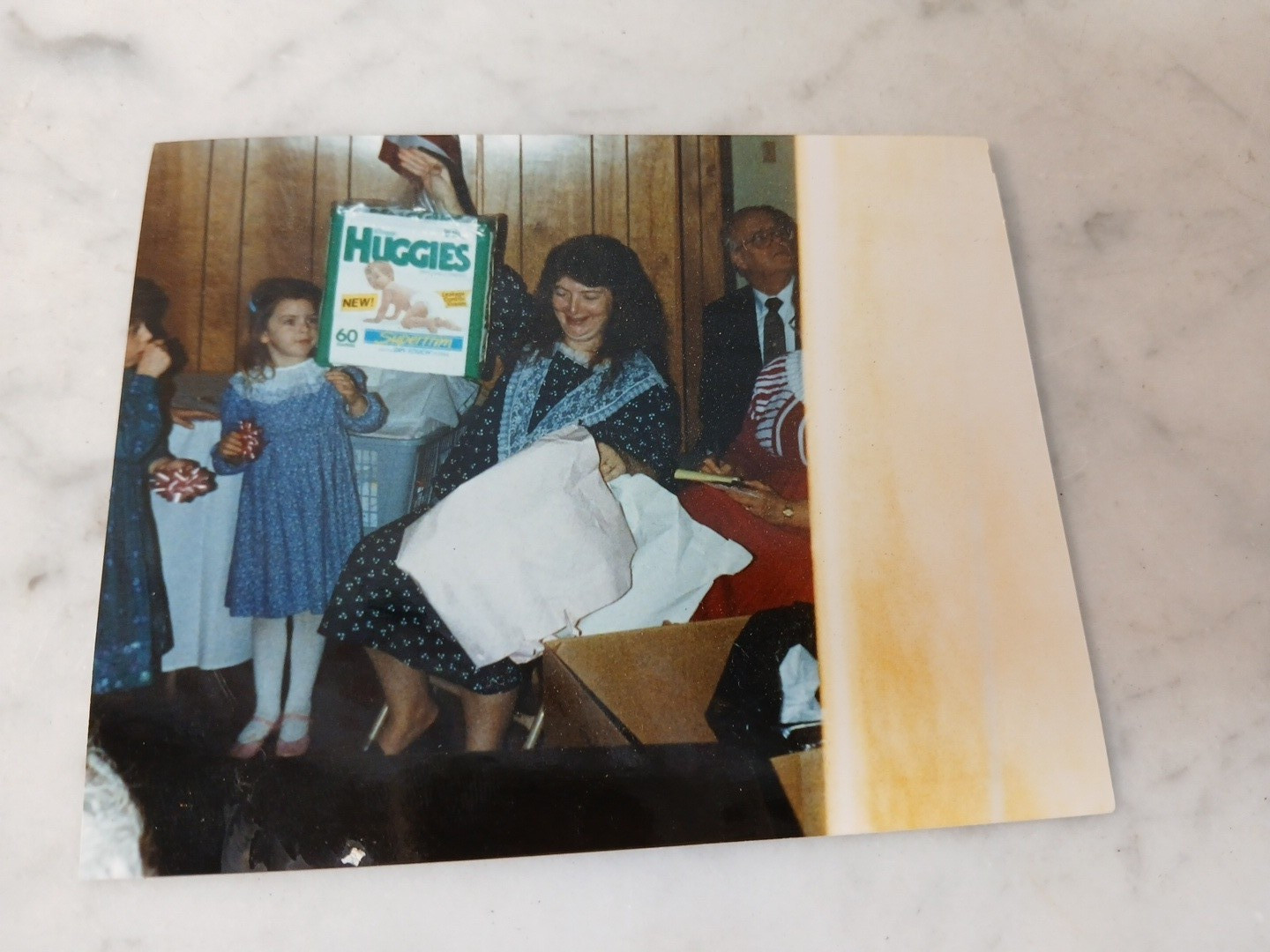 Vintage 1980s 1990s Woman Holding Huggies Baby Diapers at Baby Shower Photo