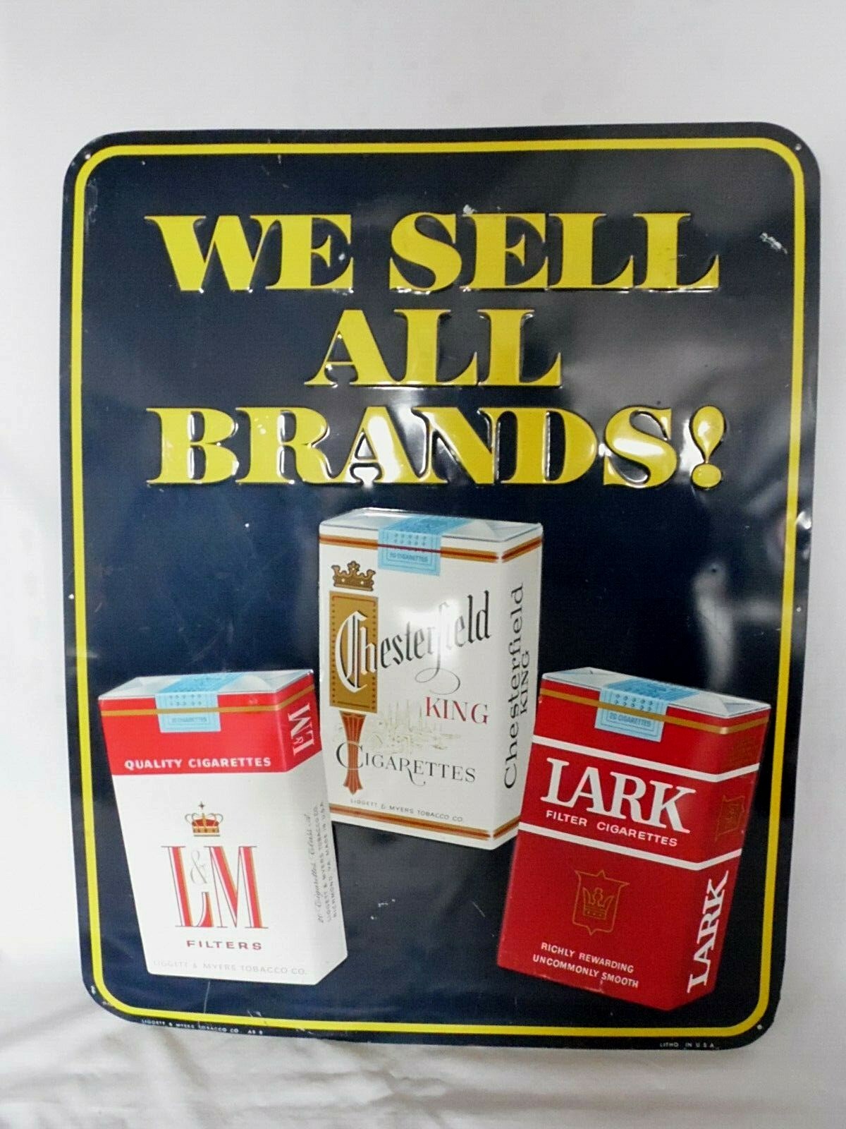 1950’s Chesterfield L&M Lark Cigarettes We Sell All Brands! Embossed Tin Sign