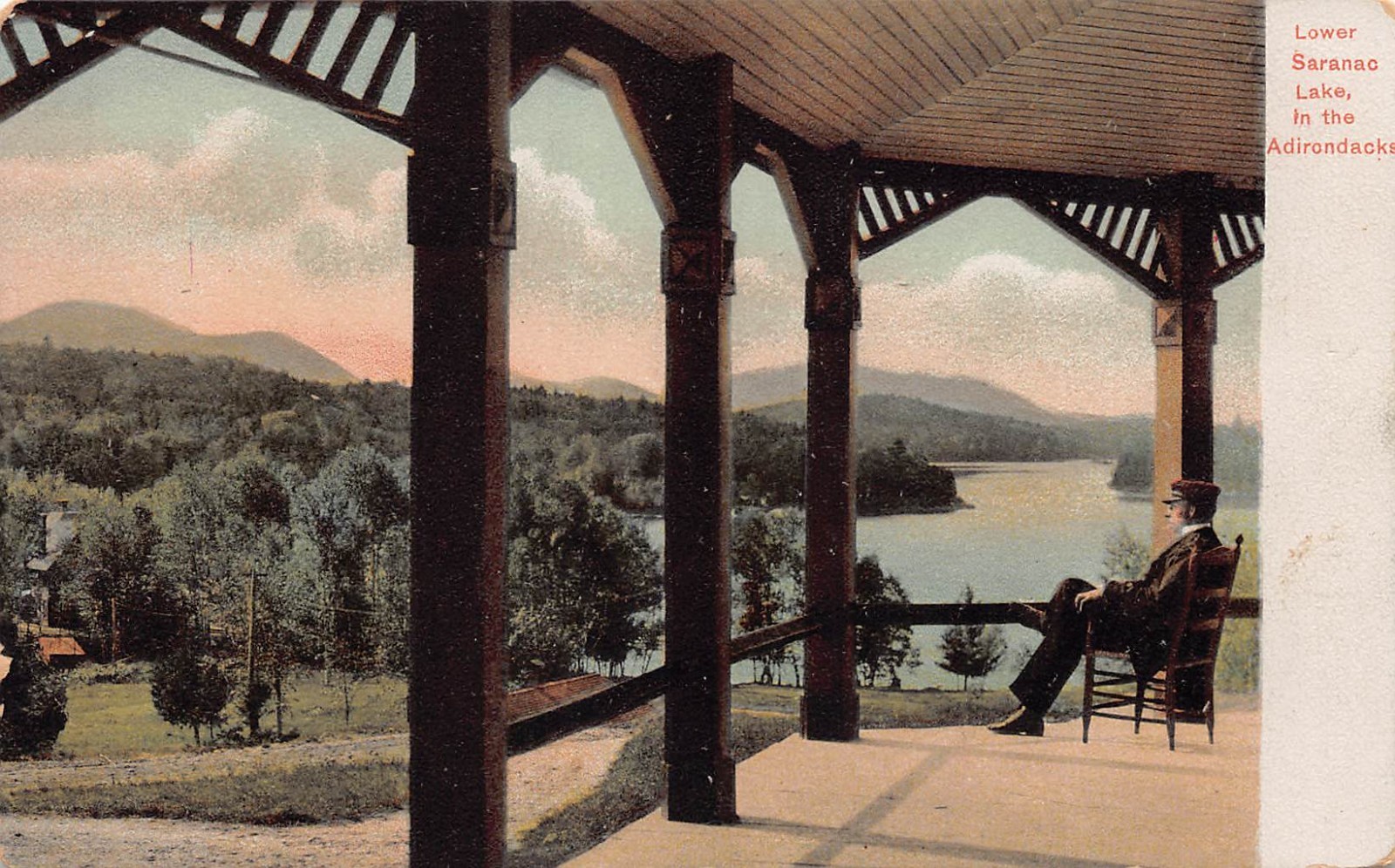 View of Lower Saranac Lake in the Adirondacks – Man on porch UDB postcard