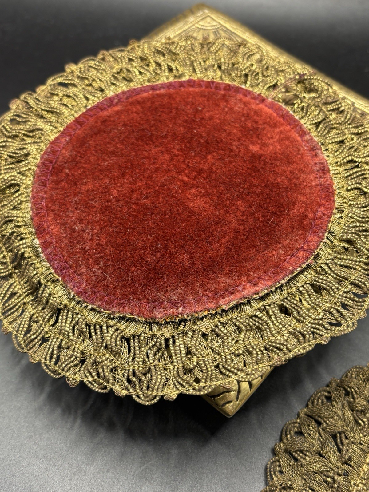 2- GOLD METALLIC THREAD EMBROIDERED TABLE DOILIE. RED LINING. FLORAL DECORATION