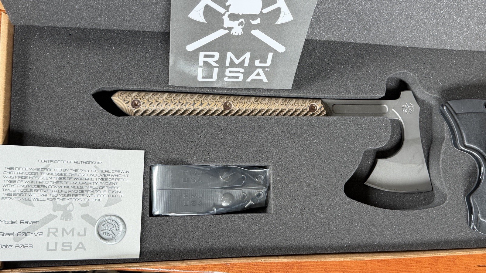 RMJ Tactical Tomahawk Raven Tungsten Body Heyena Brown G10 with Kydex Sheath