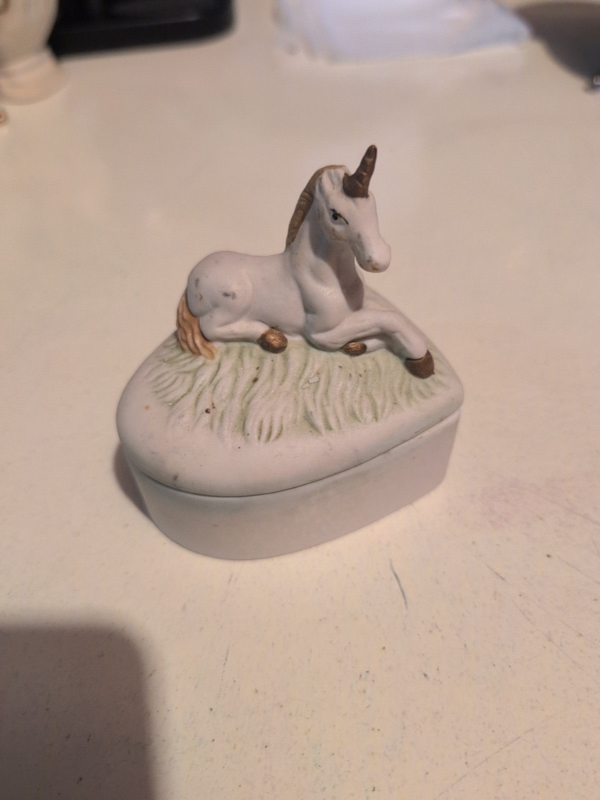 Older Unicorn Laying in Grass Hearts Shaped Trinket Box 3 5/8 W x 4″ T