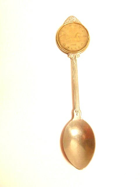 silver colored Vancouver souvenir spoon with Canadian dollar coin mounted at top
