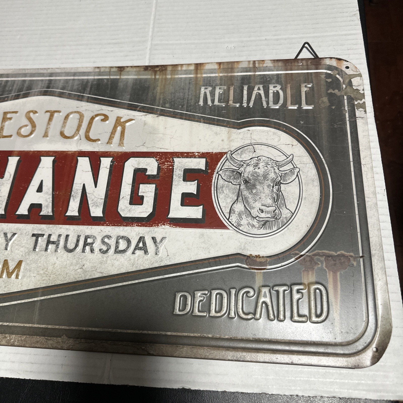 26″ x 11.5″ Weathered Livestock Exchange Embossed Metal Sign by Open Road Brands