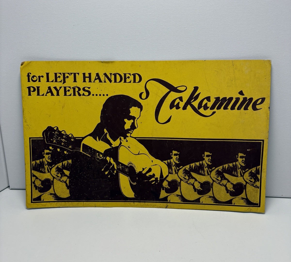 vintage advertising sign for Takamine guitars “for Left Handed Players “ 18 X 11