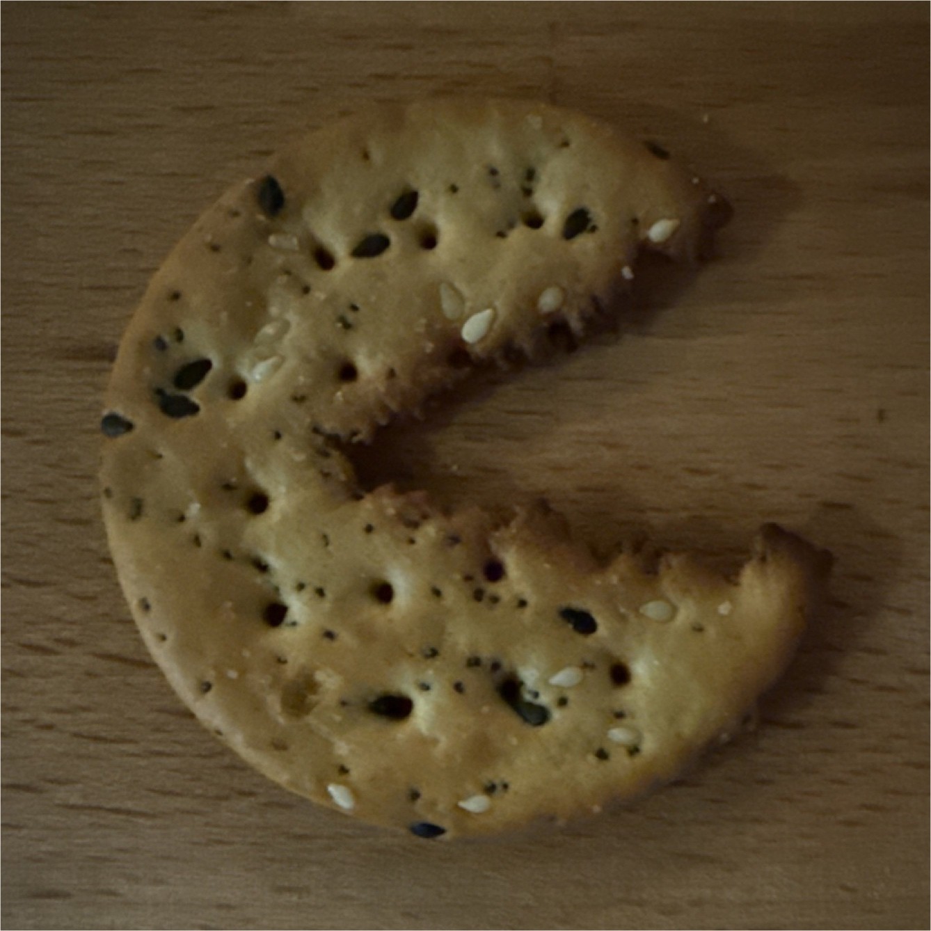 Rounded seeded cracker in the shape of pac man