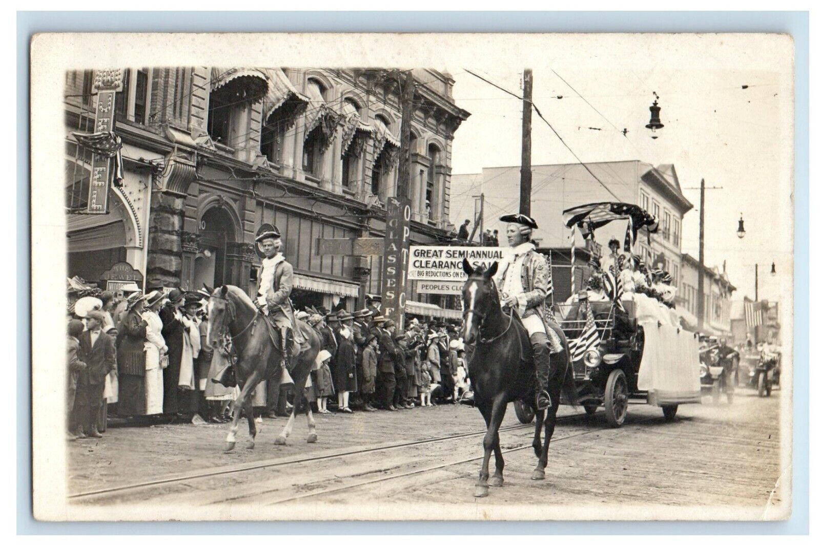 c1910’s Patriotic Parade Main Street Jewel Optometrist Kids RPPC Photo Postcard