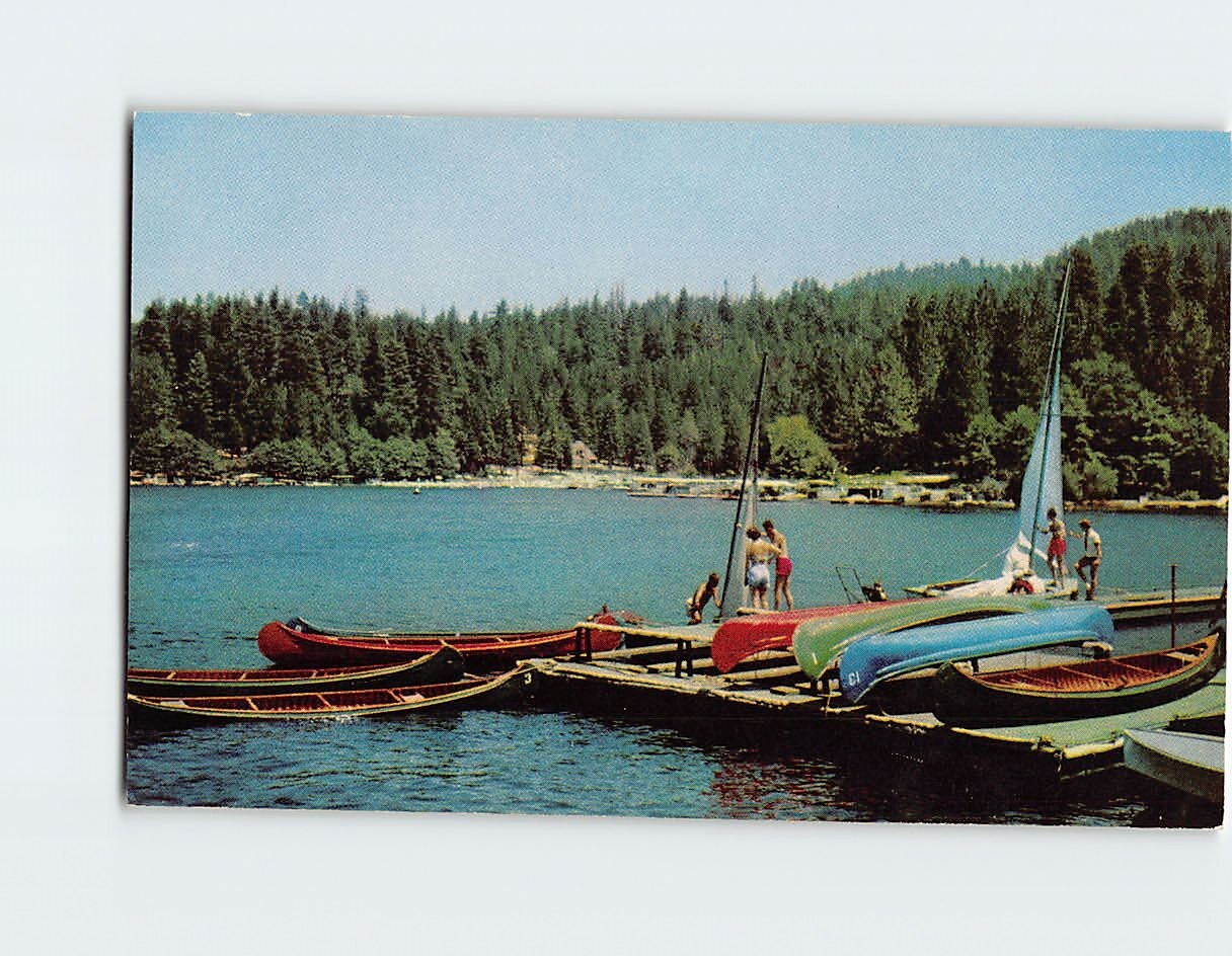 Postcard Kids swimming by the boats on the lake